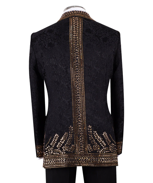 Front view of men's Gold Embellished Black Jacquard Double-Breasted Tuxedo by Charly Luxury, showcasing intricate hand-applied gold details on a black jacquard fabric.