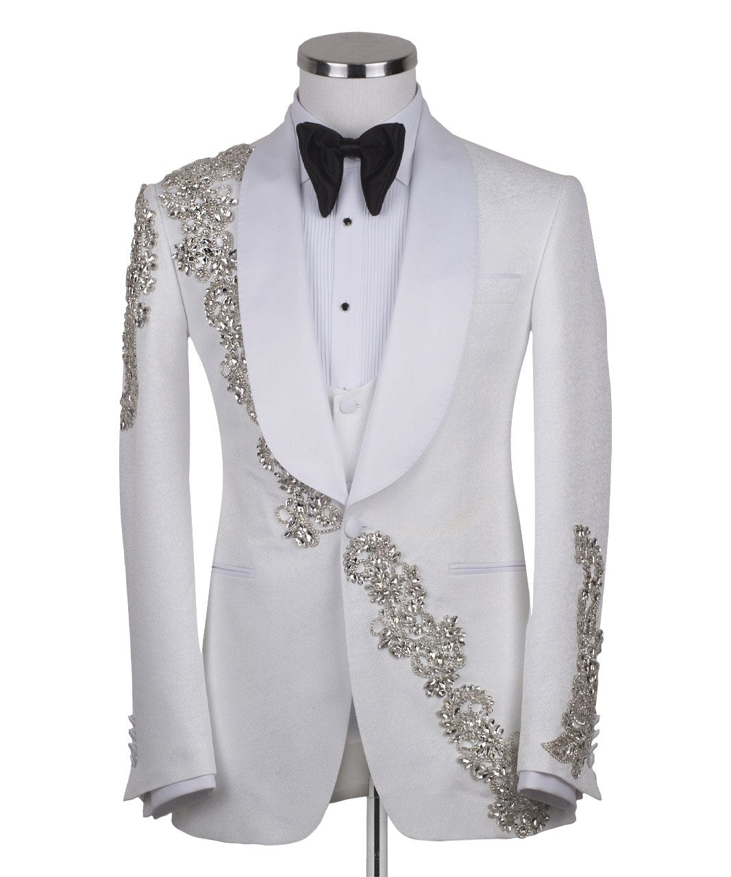 White hand-embellished jacquard three-piece tuxedo with crystal detailing on jacket and white satin shawl lapel. Master tailored in Istanbul for luxury events and weddings.