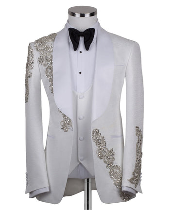 White hand-embellished jacquard three-piece tuxedo with crystal detailing on jacket and white satin shawl lapel. Master tailored in Istanbul for luxury events and weddings.