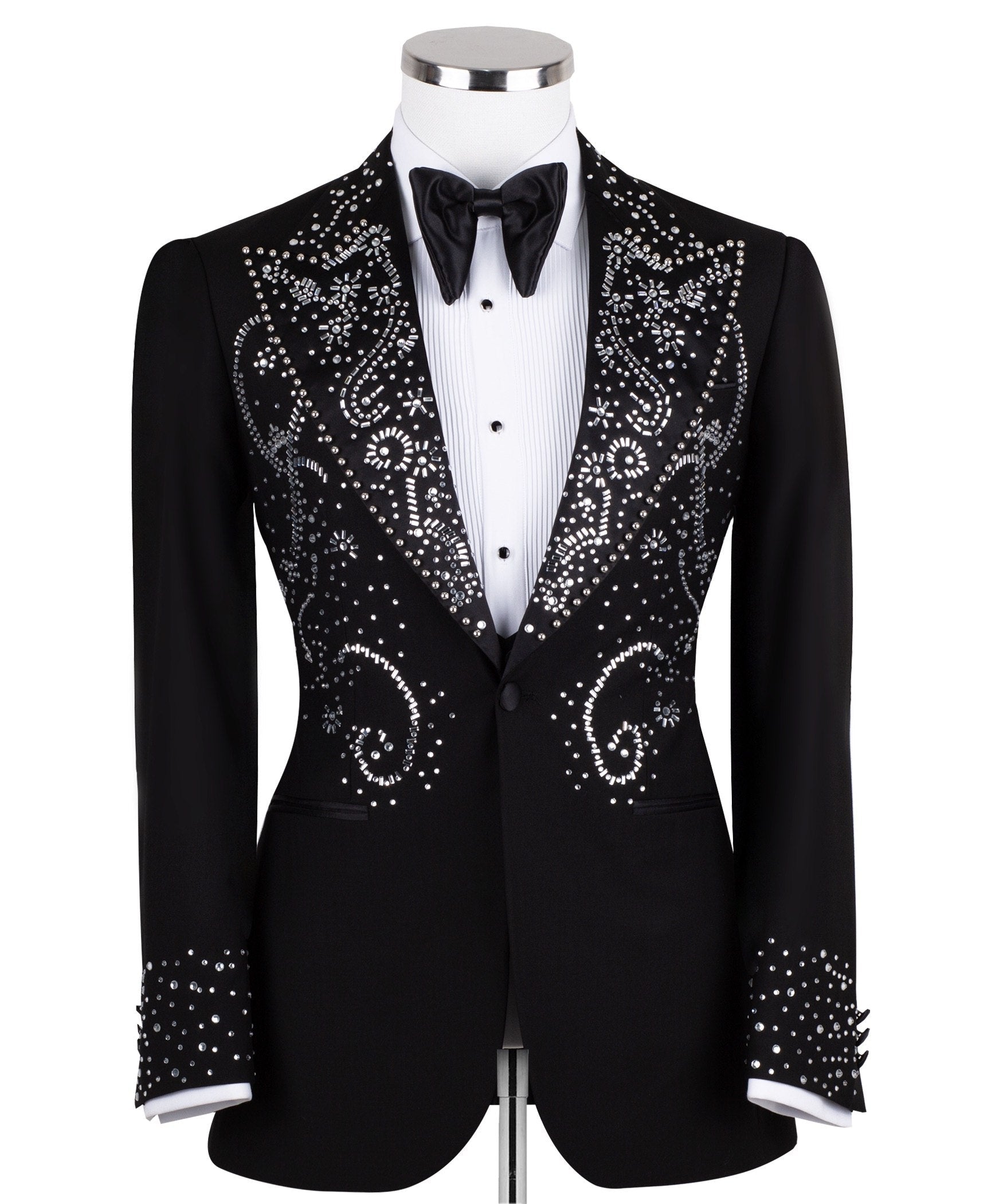 Black embellished three-piece tuxedo with intricate crystal and bead patterns on satin peak lapels, chest, and cuffs. Features a matching vest. Handcrafted luxury suit from Charly Luxury Istanbul.