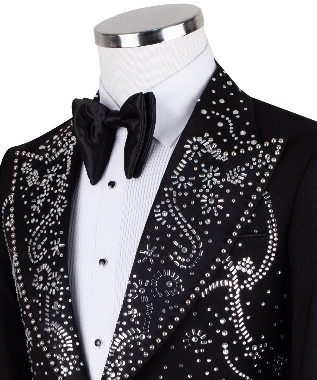 Black embellished three-piece tuxedo with intricate crystal and bead patterns on satin peak lapels, chest, and cuffs. Features a matching vest. Handcrafted luxury suit from Charly Luxury Istanbul.