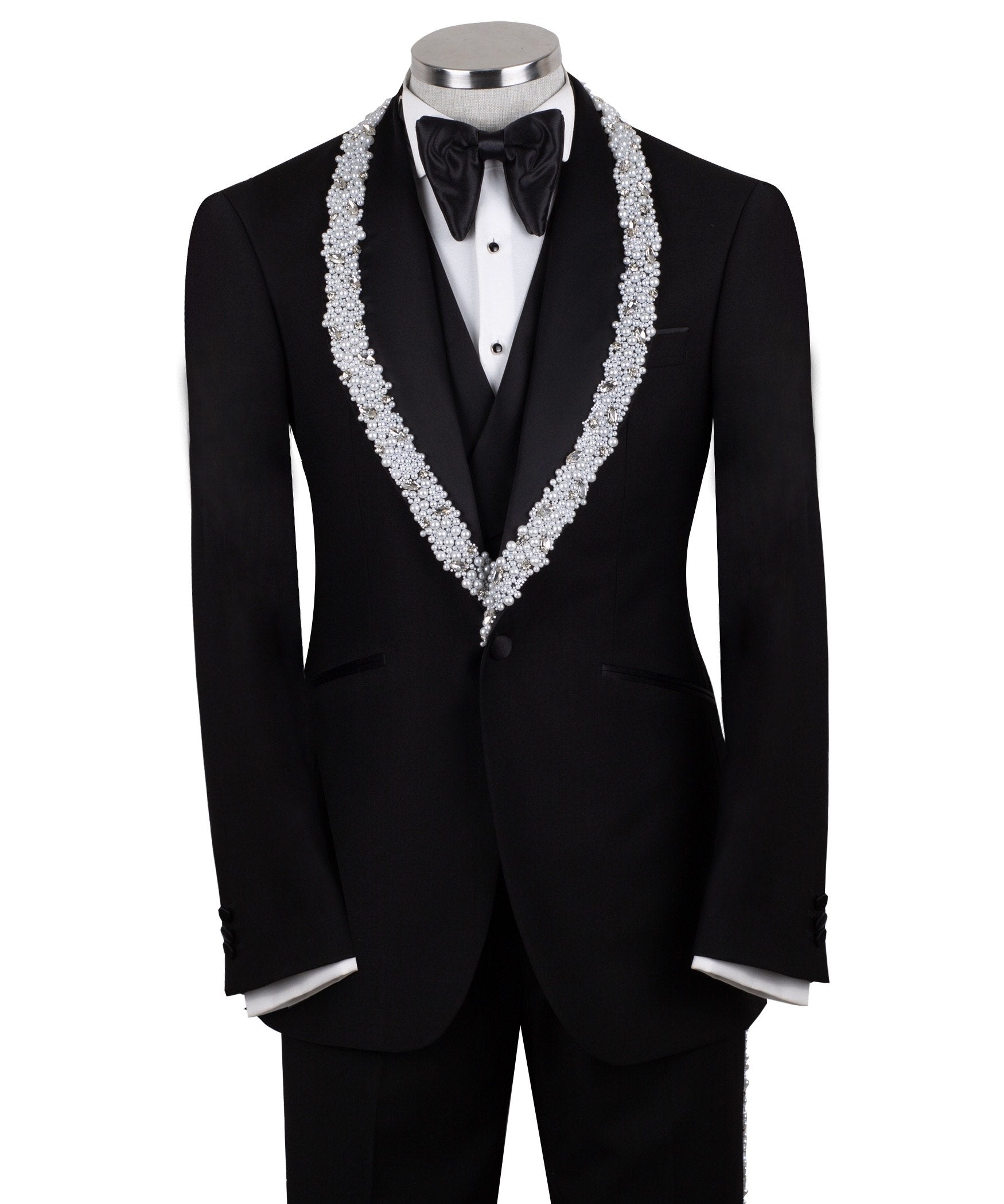 Full front view of a black three-piece tuxedo on a mannequin, featuring heavily hand-embellished shawl lapels with pearls and crystals, and a matching embellishment down the side of the trousers. Includes a black double-breasted vest and a white shirt with a black bow tie (not included).
