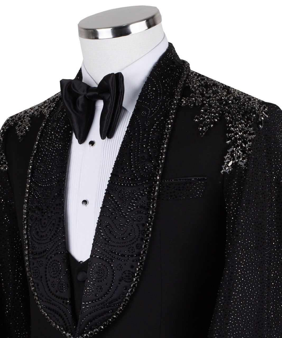 Black three-piece tuxedo on a mannequin, featuring a heavily hand-embellished shawl lapel, shoulders, and sleeves with intricate sparkling beadwork. The tuxedo includes a matching black vest and trousers, designed in a slim fit style, showcasing luxurious craftsmanship from Istanbul.