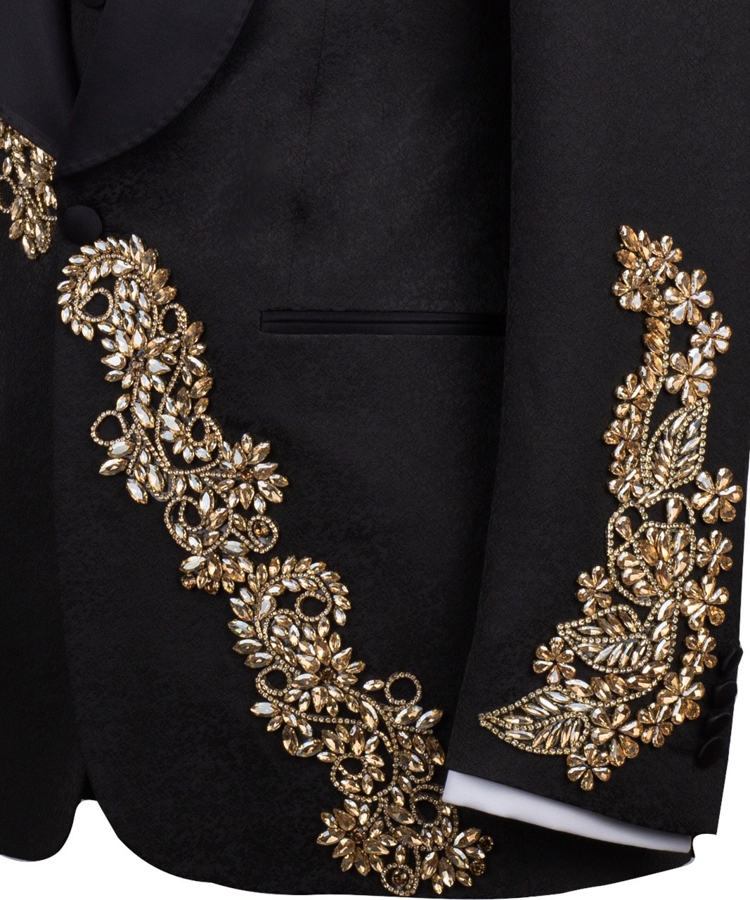 Front view of a black jacquard three-piece tuxedo with intricate gold hand-embellishments on the shawl lapel, shoulder, and cuffs, displayed on a mannequin. From Charly Luxury, handcrafted in Istanbul.