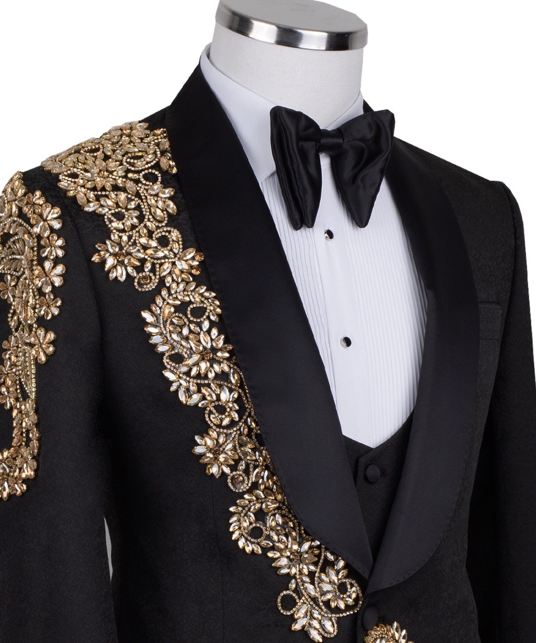 Front view of a black jacquard three-piece tuxedo with intricate gold hand-embellishments on the shawl lapel, shoulder, and cuffs, displayed on a mannequin. From Charly Luxury, handcrafted in Istanbul.