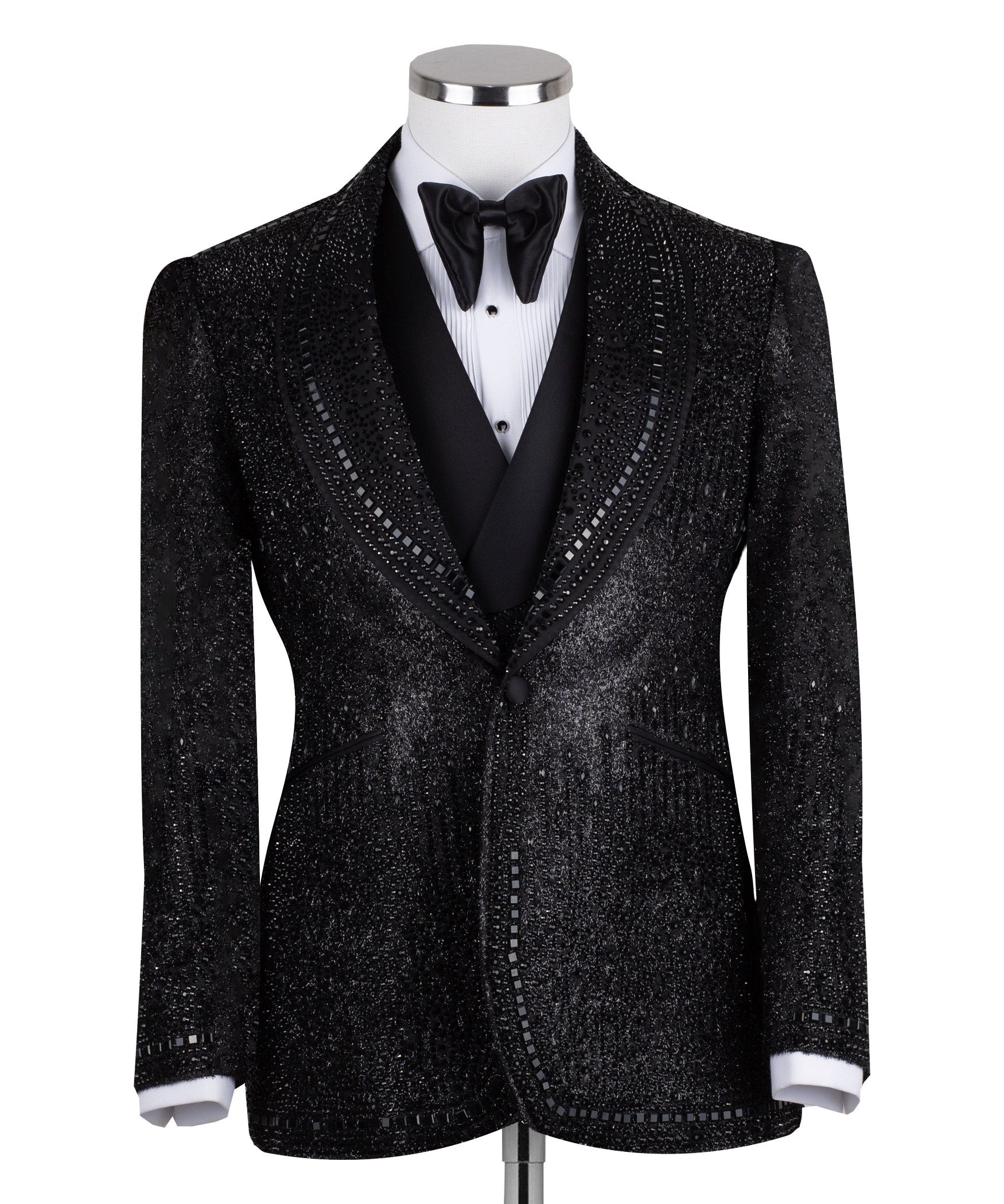 Front view of a black hand-embellished three-piece tuxedo by Charly Luxury, featuring a single-breasted jacket with satin shawl lapels and a double-breasted vest, showcased on a mannequin.