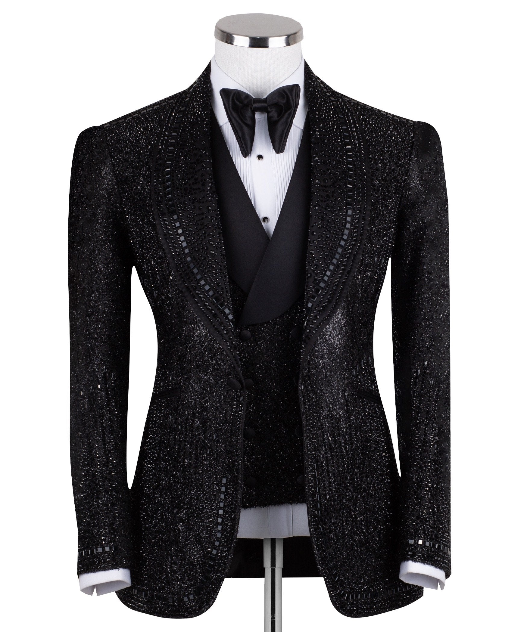 Front view of a black hand-embellished three-piece tuxedo by Charly Luxury, featuring a single-breasted jacket with satin shawl lapels and a double-breasted vest, showcased on a mannequin.