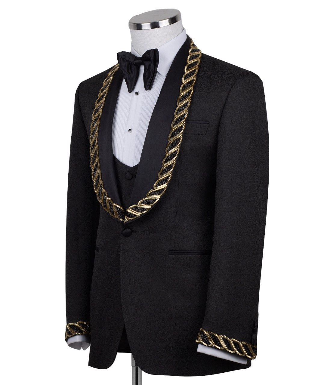 Front view of Charly Luxury's black jacquard three-piece tuxedo with opulent gold chain embellishments on the shawl lapel and cuffs, tailored in Istanbul. Includes jacket, vest, and trousers.