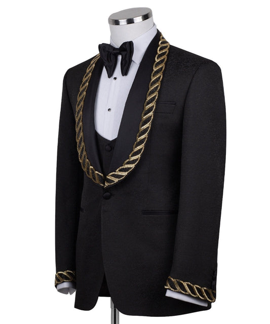 Front view of Charly Luxury's black jacquard three-piece tuxedo with opulent gold chain embellishments on the shawl lapel and cuffs, tailored in Istanbul. Includes jacket, vest, and trousers.