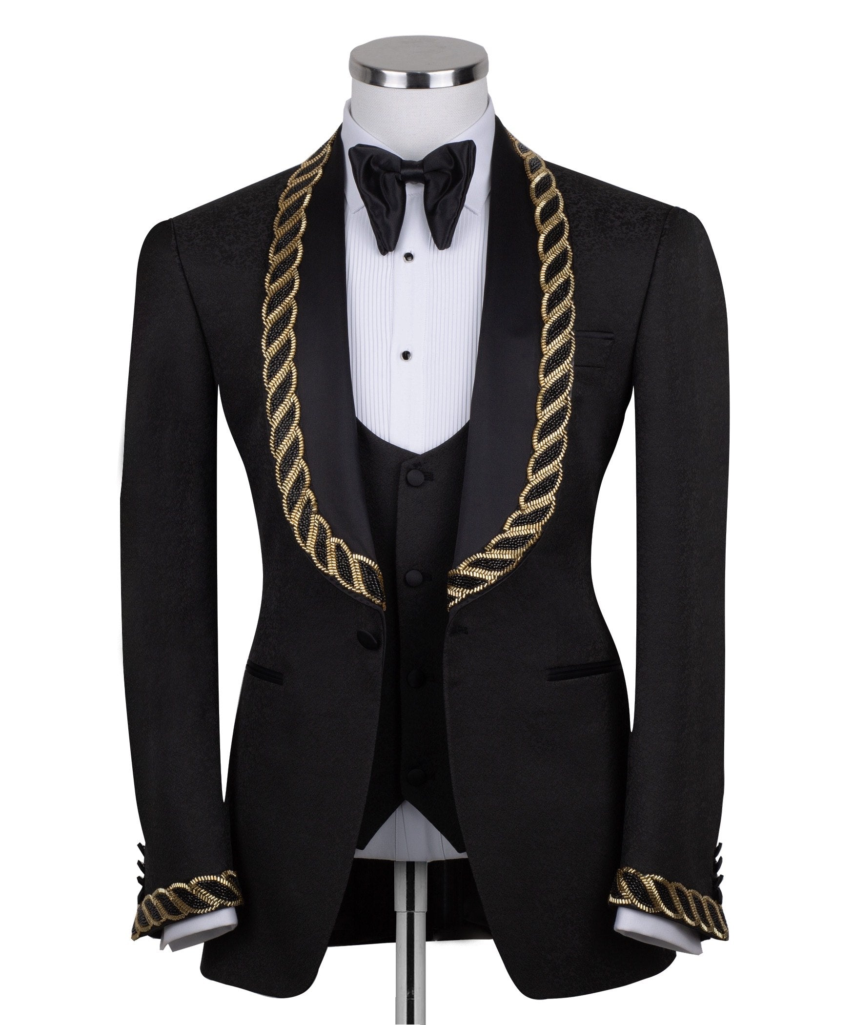 Front view of Charly Luxury's black jacquard three-piece tuxedo with opulent gold chain embellishments on the shawl lapel and cuffs, tailored in Istanbul. Includes jacket, vest, and trousers.