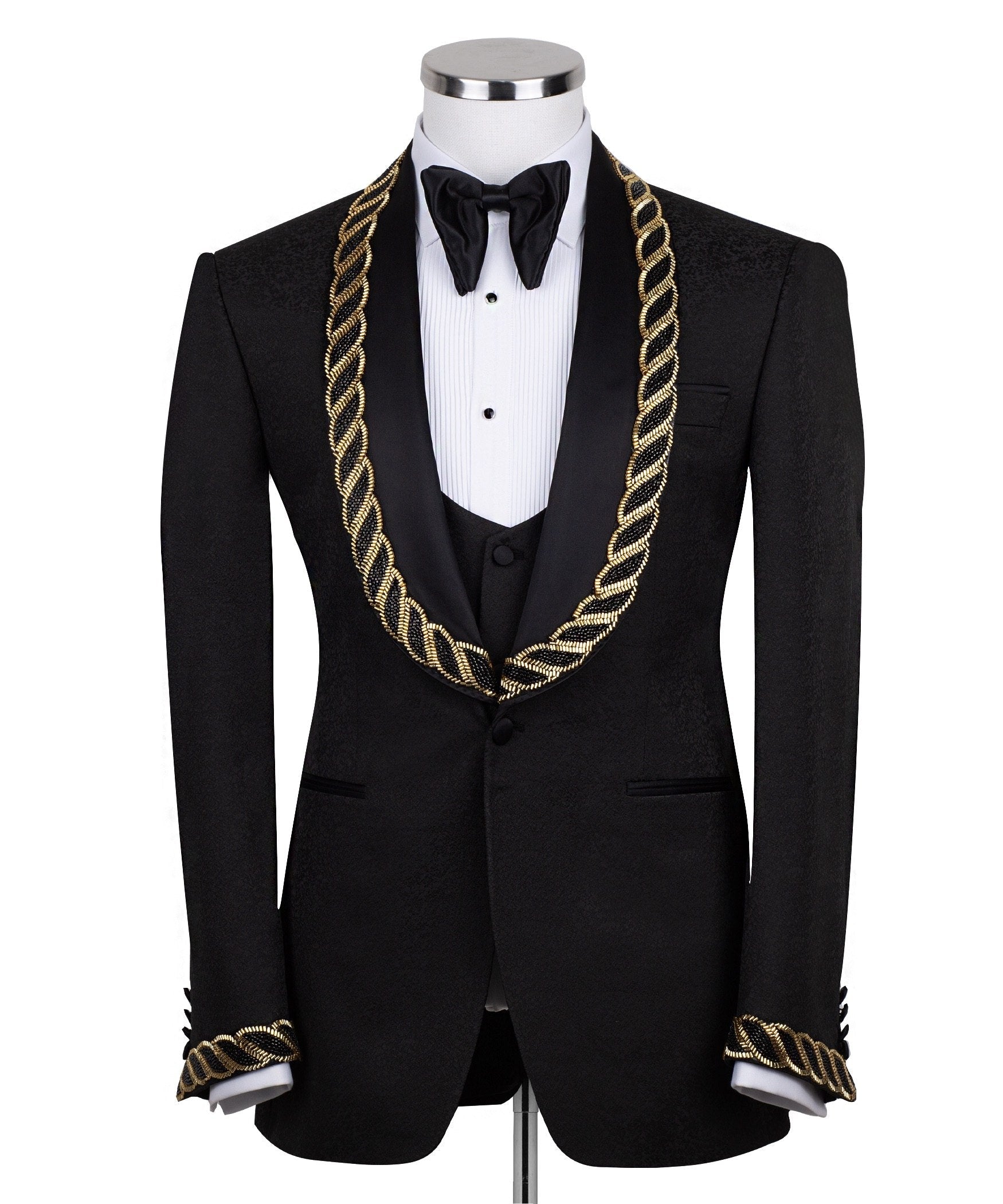 Front view of Charly Luxury's black jacquard three-piece tuxedo with opulent gold chain embellishments on the shawl lapel and cuffs, tailored in Istanbul. Includes jacket, vest, and trousers.
