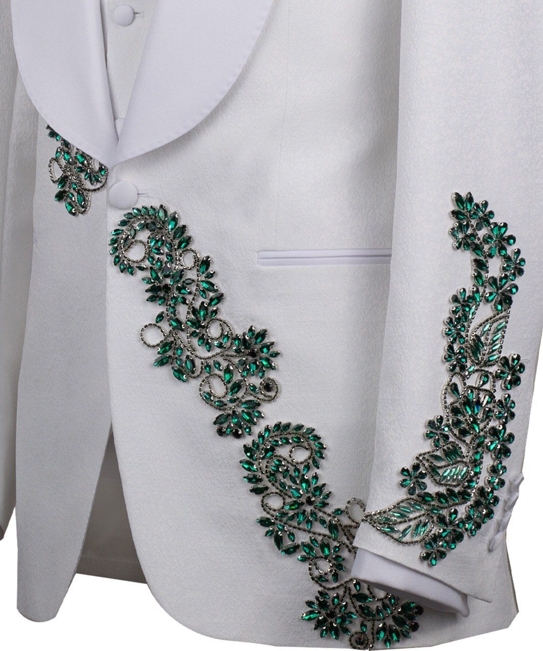 Charly Luxury white three-piece tuxedo with intricate emerald green hand-embellished details on the jacket, shoulders, and sleeves. Features a white shawl lapel and vest. Front view and side view of the luxury suit on a mannequin.