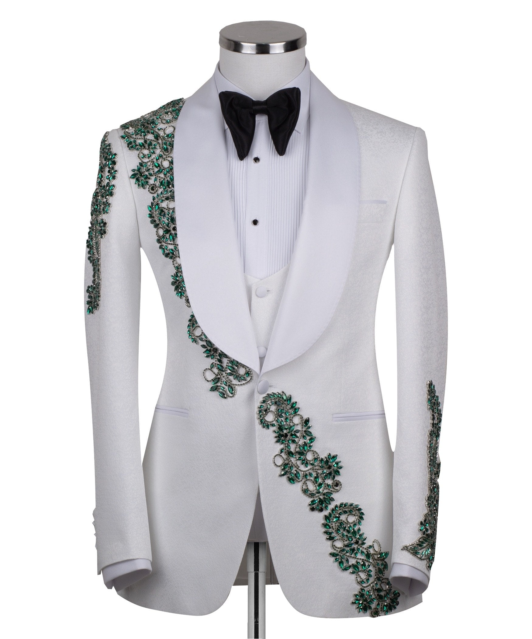 Charly Luxury white three-piece tuxedo with intricate emerald green hand-embellished details on the jacket, shoulders, and sleeves. Features a white shawl lapel and vest. Front view and side view of the luxury suit on a mannequin.