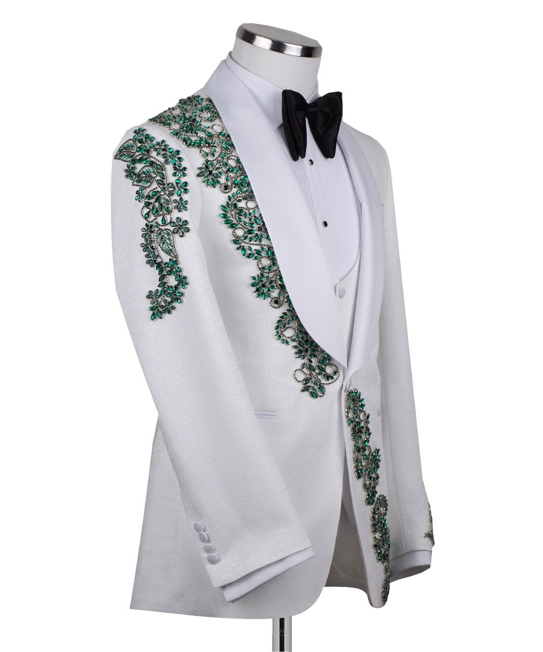 Charly Luxury white three-piece tuxedo with intricate emerald green hand-embellished details on the jacket, shoulders, and sleeves. Features a white shawl lapel and vest. Front view and side view of the luxury suit on a mannequin.
