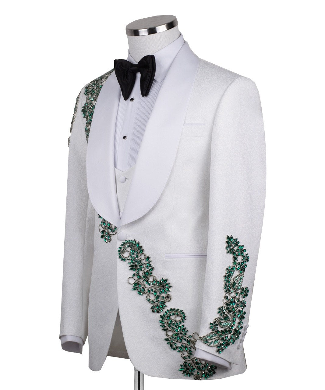 Charly Luxury white three-piece tuxedo with intricate emerald green hand-embellished details on the jacket, shoulders, and sleeves. Features a white shawl lapel and vest. Front view and side view of the luxury suit on a mannequin.