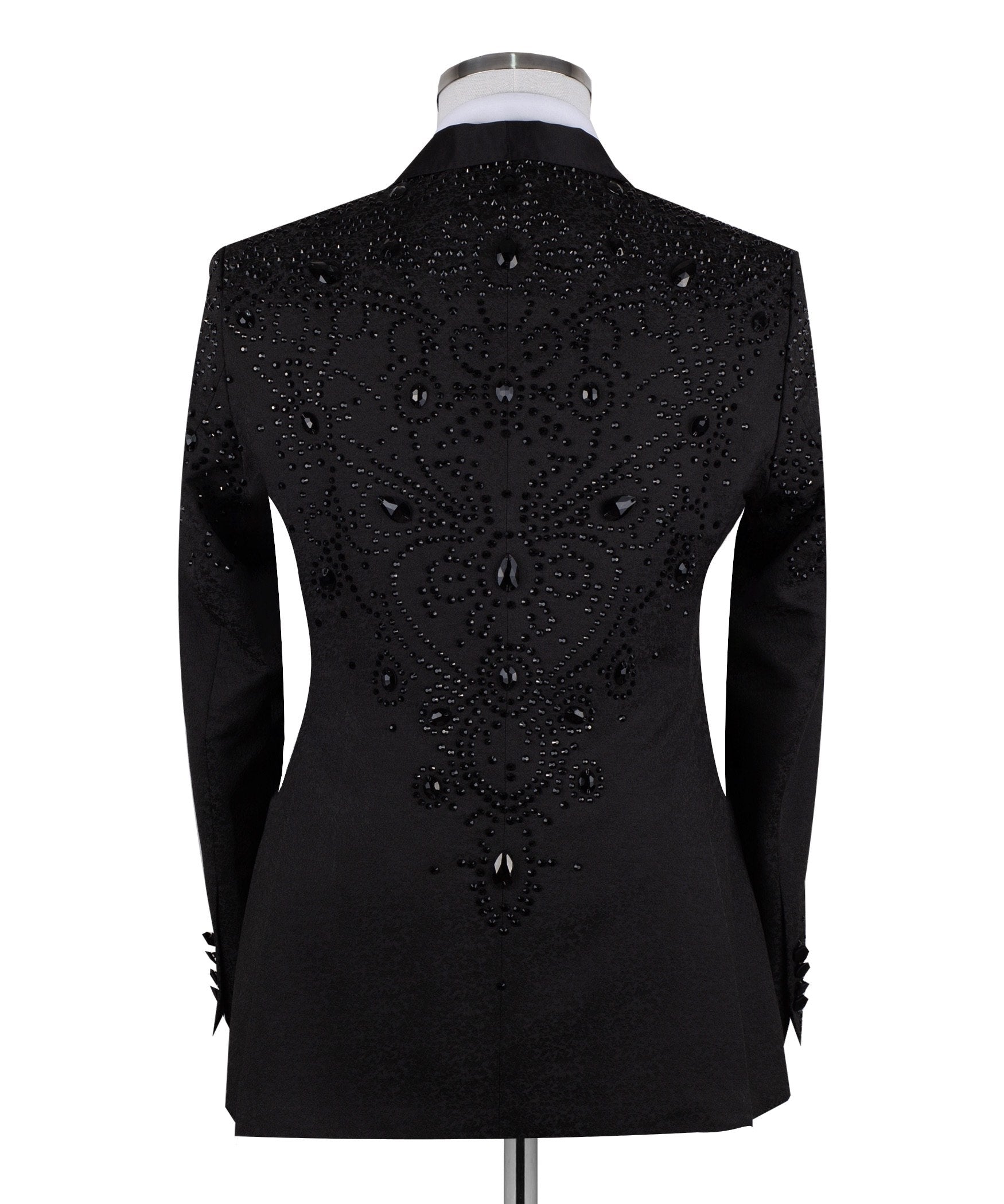 Black hand-embellished three-piece tuxedo by Charly Luxury, featuring an intricate beaded pattern on the shoulders and back, satin shawl lapel, and matching vest and trousers. Masterfully crafted in Istanbul for luxury events.