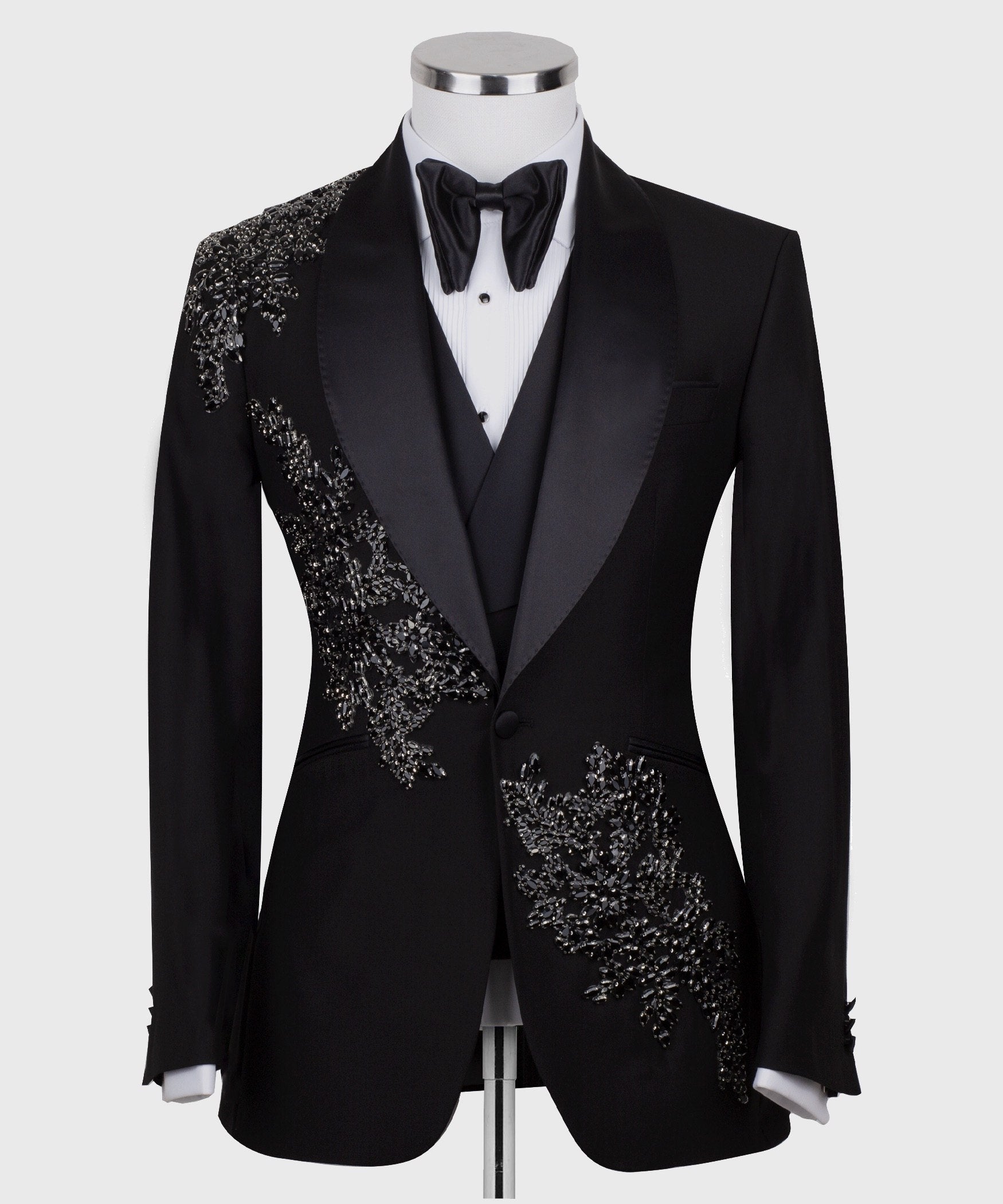 Charly Luxury Black Embellished Three-Piece Tuxedo. Handcrafted single-breasted jacket with peak lapel and shimmering crystal embellishments. Includes matching double-breasted vest and trousers.
