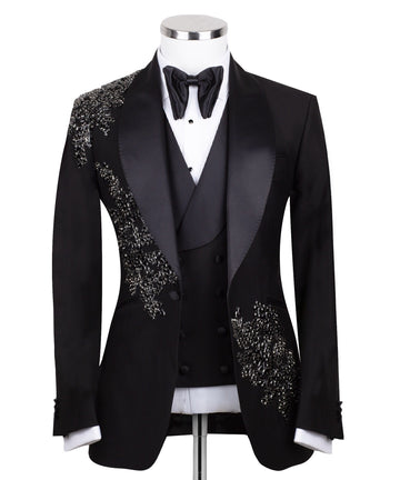 Charly Luxury Black Embellished Three-Piece Tuxedo. Handcrafted single-breasted jacket with peak lapel and shimmering crystal embellishments. Includes matching double-breasted vest and trousers.