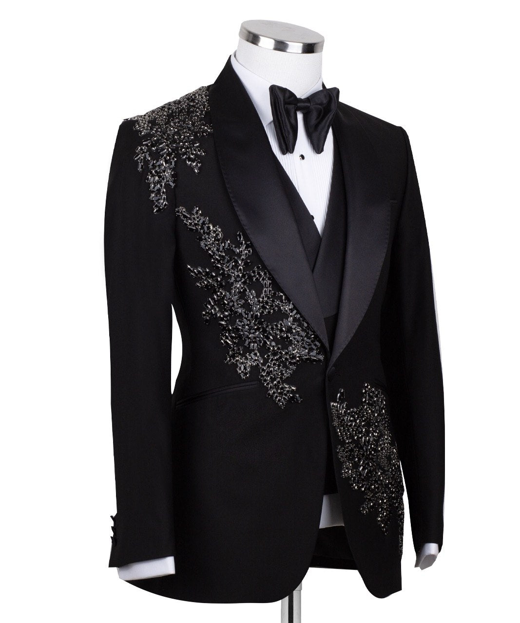 Charly Luxury Black Embellished Three-Piece Tuxedo. Handcrafted single-breasted jacket with peak lapel and shimmering crystal embellishments. Includes matching double-breasted vest and trousers.