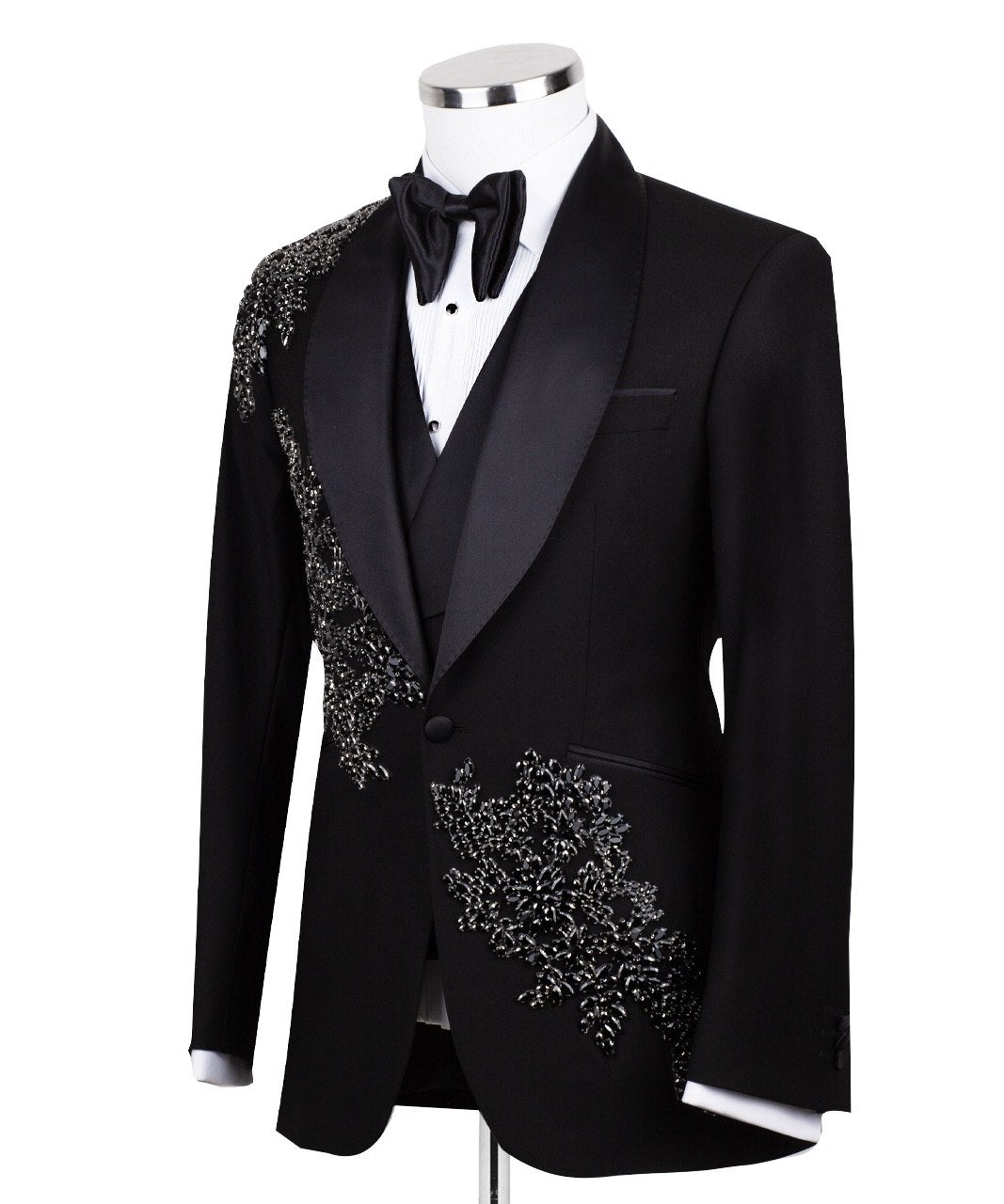 Charly Luxury Black Embellished Three-Piece Tuxedo. Handcrafted single-breasted jacket with peak lapel and shimmering crystal embellishments. Includes matching double-breasted vest and trousers.