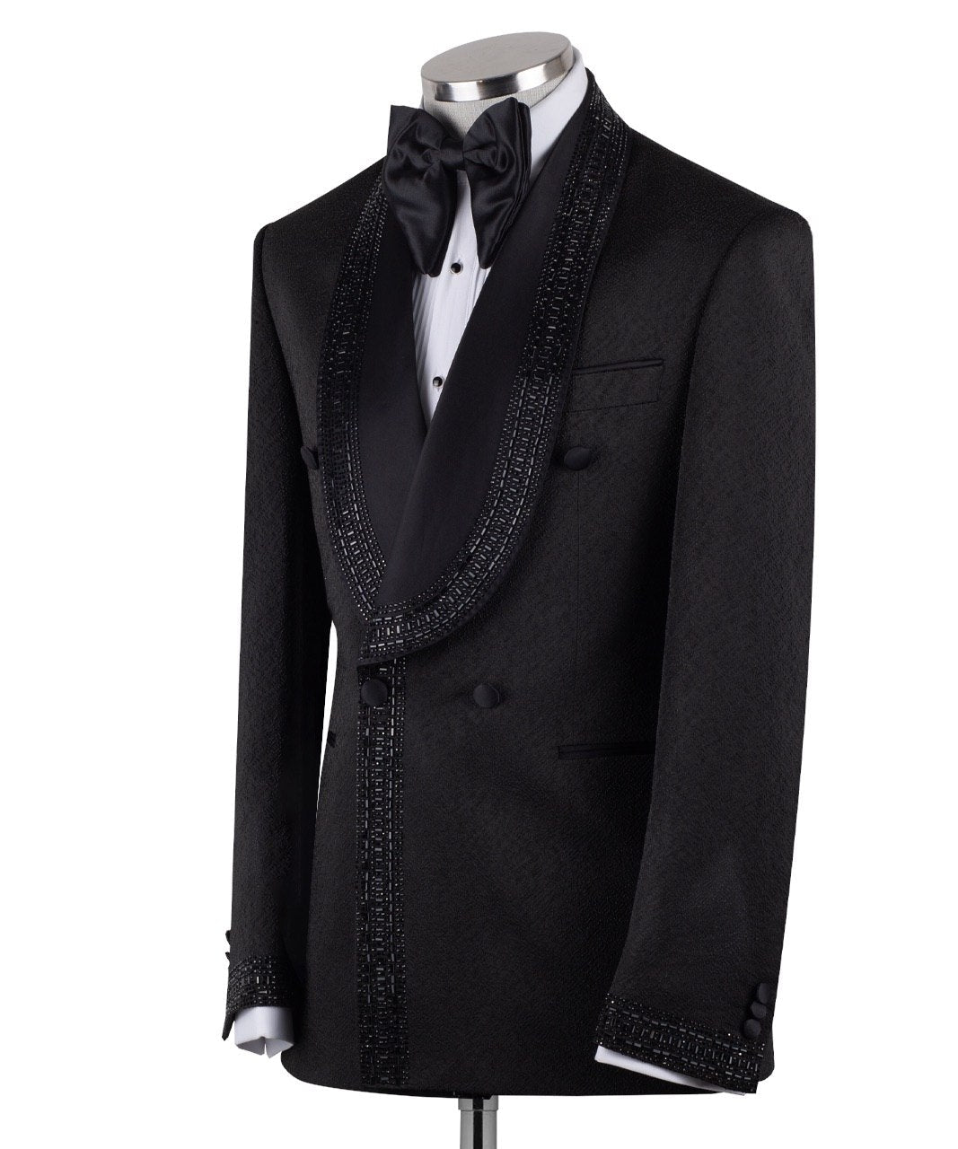 Front view of a black textured double-breasted tuxedo with hand-embellished shawl lapels, cuffs, and front trim. The trousers have a satin side stripe. High-end luxury formal wear from Charly Luxury.