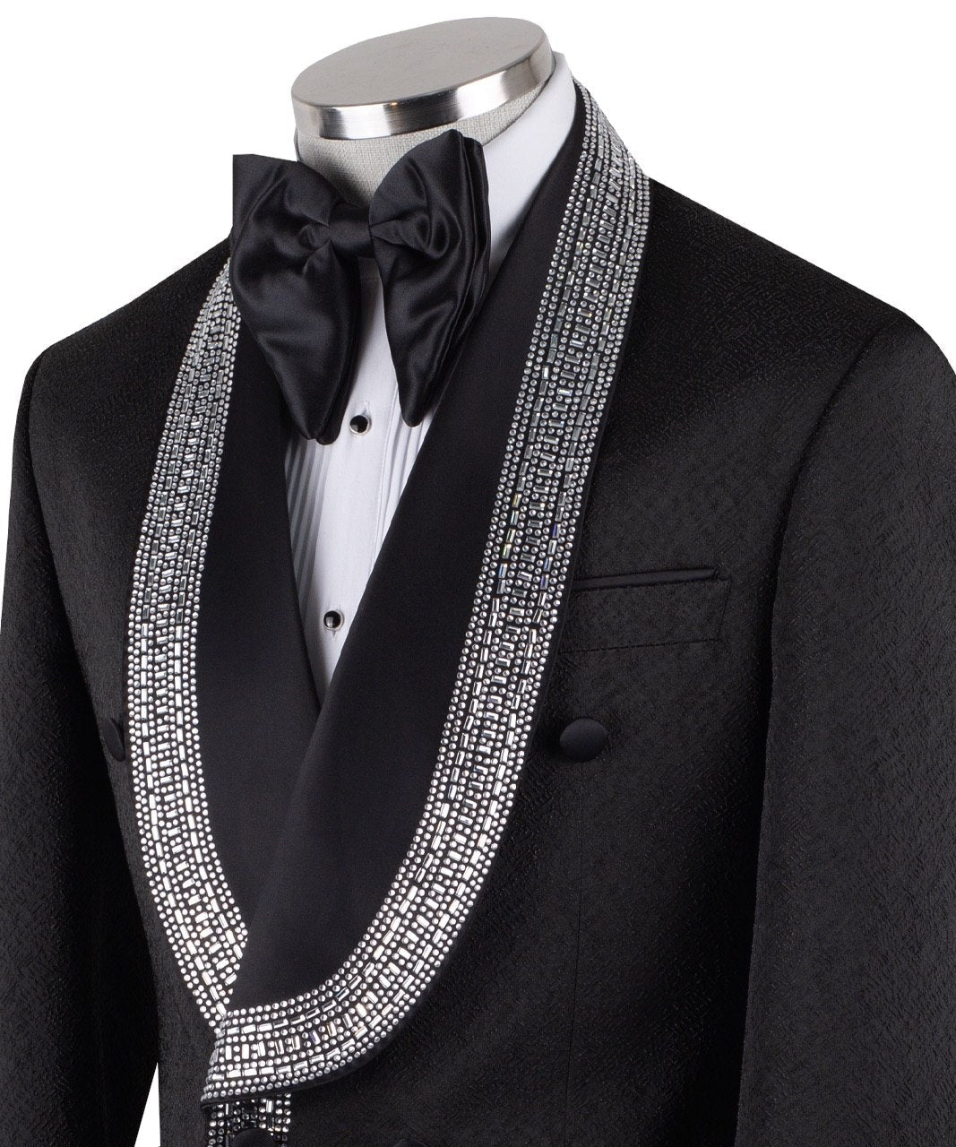 Black double-breasted tuxedo jacket with intricate silver hand-embellished shawl lapels, front detail, and cuffs, paired with black satin stripe trousers on a mannequin. From Charly Luxury, handcrafted in Istanbul.