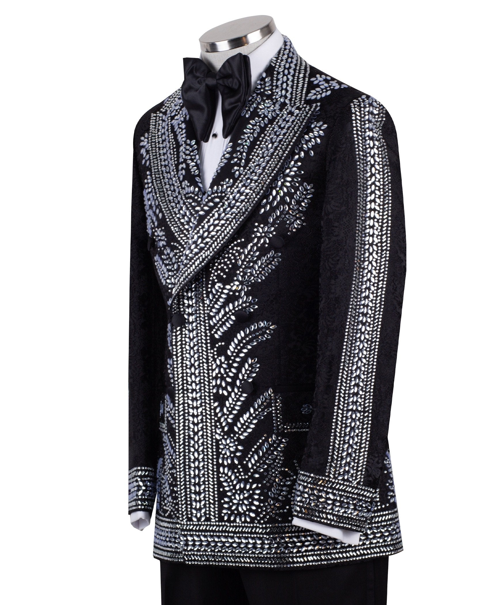 Front view of a black double-breasted tuxedo jacket with extensive silver embellishments, featuring a peak lapel and slim fit design on a mannequin. Back view and close-up showing intricate hand-beading detail.