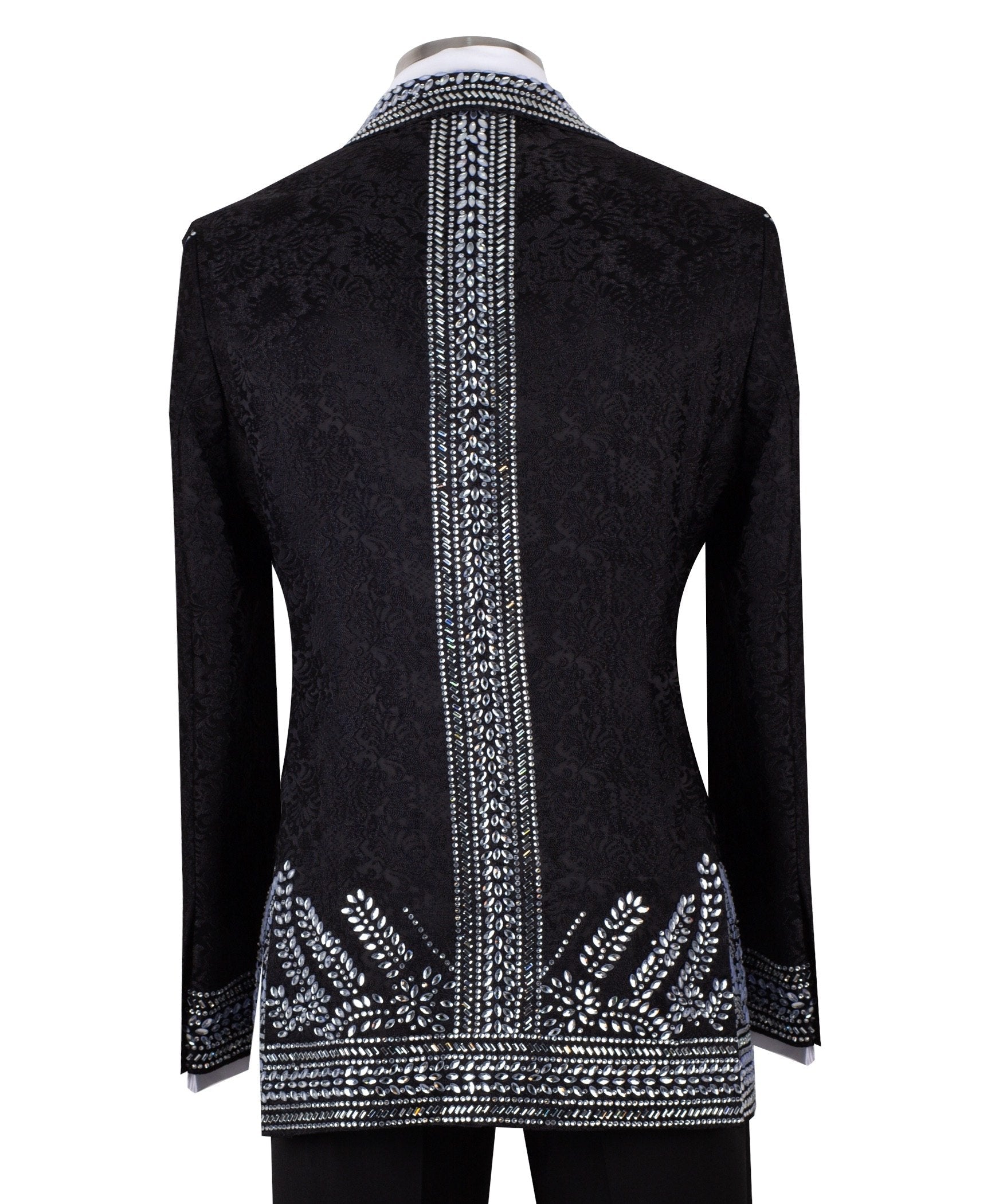 Front view of a black double-breasted tuxedo jacket with extensive silver embellishments, featuring a peak lapel and slim fit design on a mannequin. Back view and close-up showing intricate hand-beading detail.