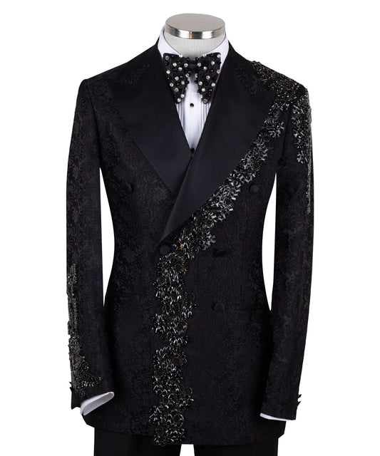 Black embellished jacquard double-breasted tuxedo with satin peak lapels and hand-beaded details on the shoulders and lapel, shown with matching plain black trousers with satin side stripe, handcrafted by Charly Luxury in Istanbul.