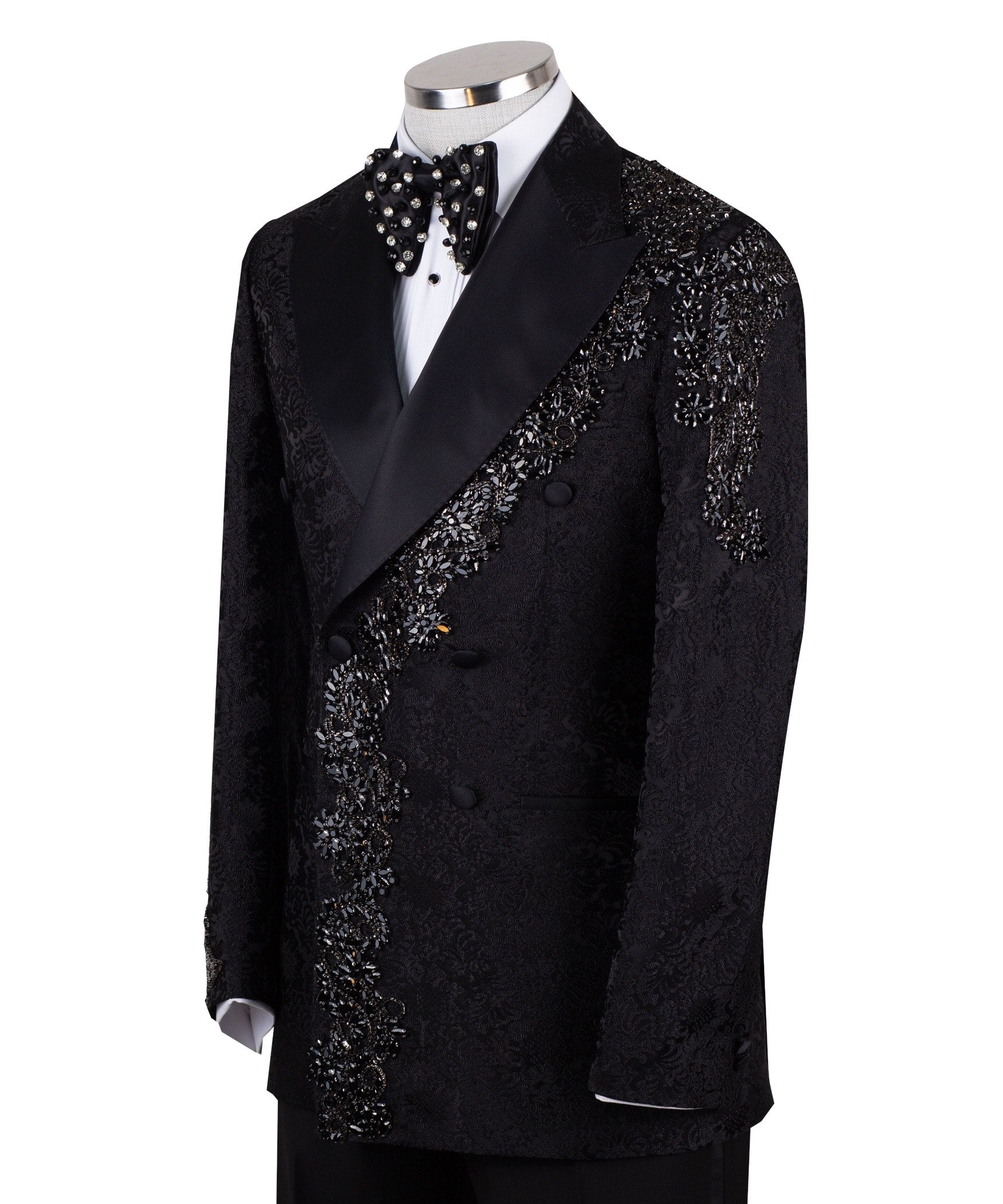 Black embellished jacquard double-breasted tuxedo with satin peak lapels and hand-beaded details on the shoulders and lapel, shown with matching plain black trousers with satin side stripe, handcrafted by Charly Luxury in Istanbul.