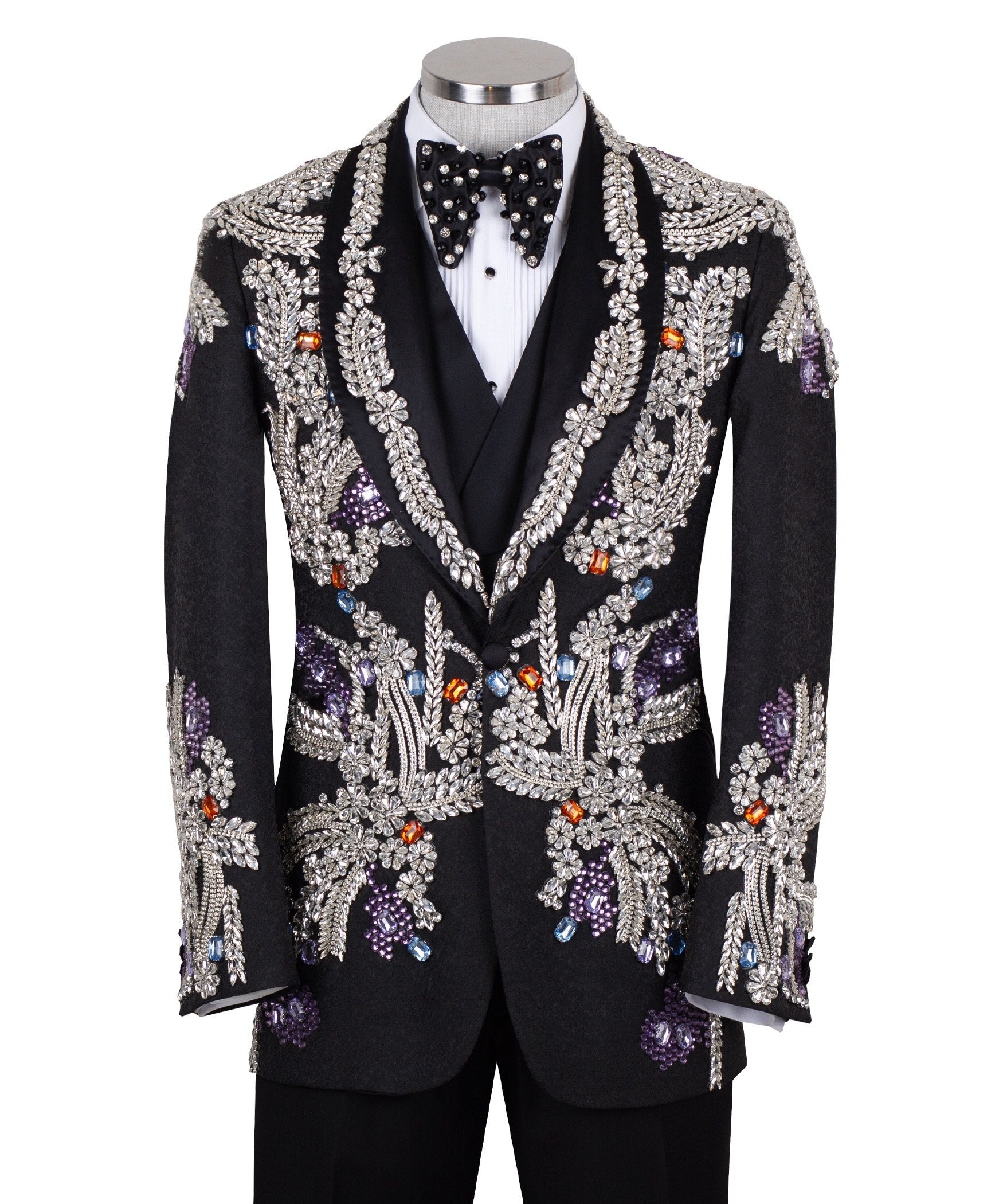 Front and side view of a black tuxedo jacket with extensive silver, purple, orange, and blue crystal and gemstone embellishments in floral and baroque patterns, paired with matching black trousers and vest, on a mannequin. Showcases intricate hand-embellished details and luxurious craftsmanship from Charly Luxury, Istanbul.