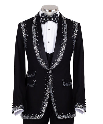 Charly Luxury Black Embellished Shawl Lapel Tuxedo, featuring shimmering silver crystals hand-embellished on lapels, shoulders, pockets, and cuffs. The tuxedo includes a black single-breasted jacket, matching vest, and trousers, displayed on a mannequin. This luxury evening wear is handcrafted in Istanbul, showcasing master tailoring and intricate crystal detailing for a glamorous, statement look.