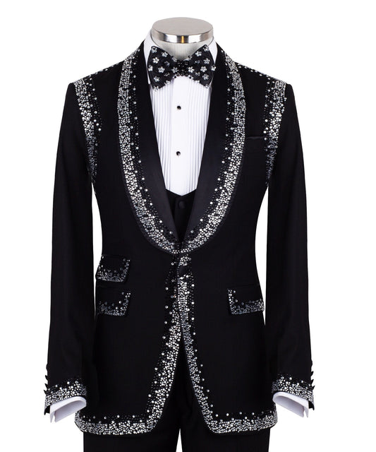 Charly Luxury Black Embellished Shawl Lapel Tuxedo, featuring shimmering silver crystals hand-embellished on lapels, shoulders, pockets, and cuffs. The tuxedo includes a black single-breasted jacket, matching vest, and trousers, displayed on a mannequin. This luxury evening wear is handcrafted in Istanbul, showcasing master tailoring and intricate crystal detailing for a glamorous, statement look.
