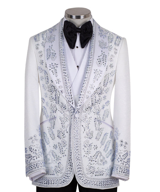 Front view of a white heavily embellished three-piece tuxedo with silver sequins and beadwork, featuring a shawl lapel and a matching white vest, displayed on a mannequin. Handmade in Istanbul.