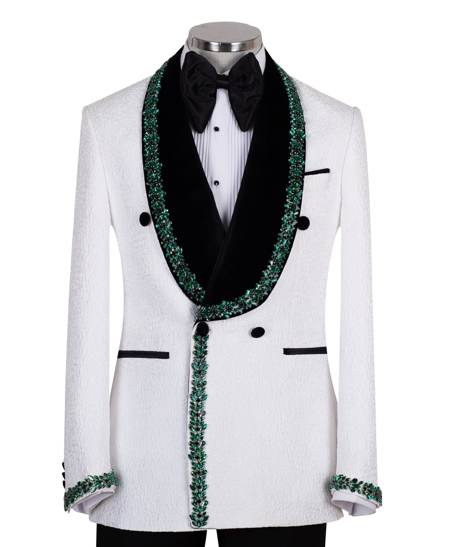 White double-breasted tuxedo jacket with textured fabric, black velvet shawl lapel, emerald green hand-embellished jewels, black buttons, and matching black trousers. Luxurious, handcrafted in Istanbul by Charly Luxury.