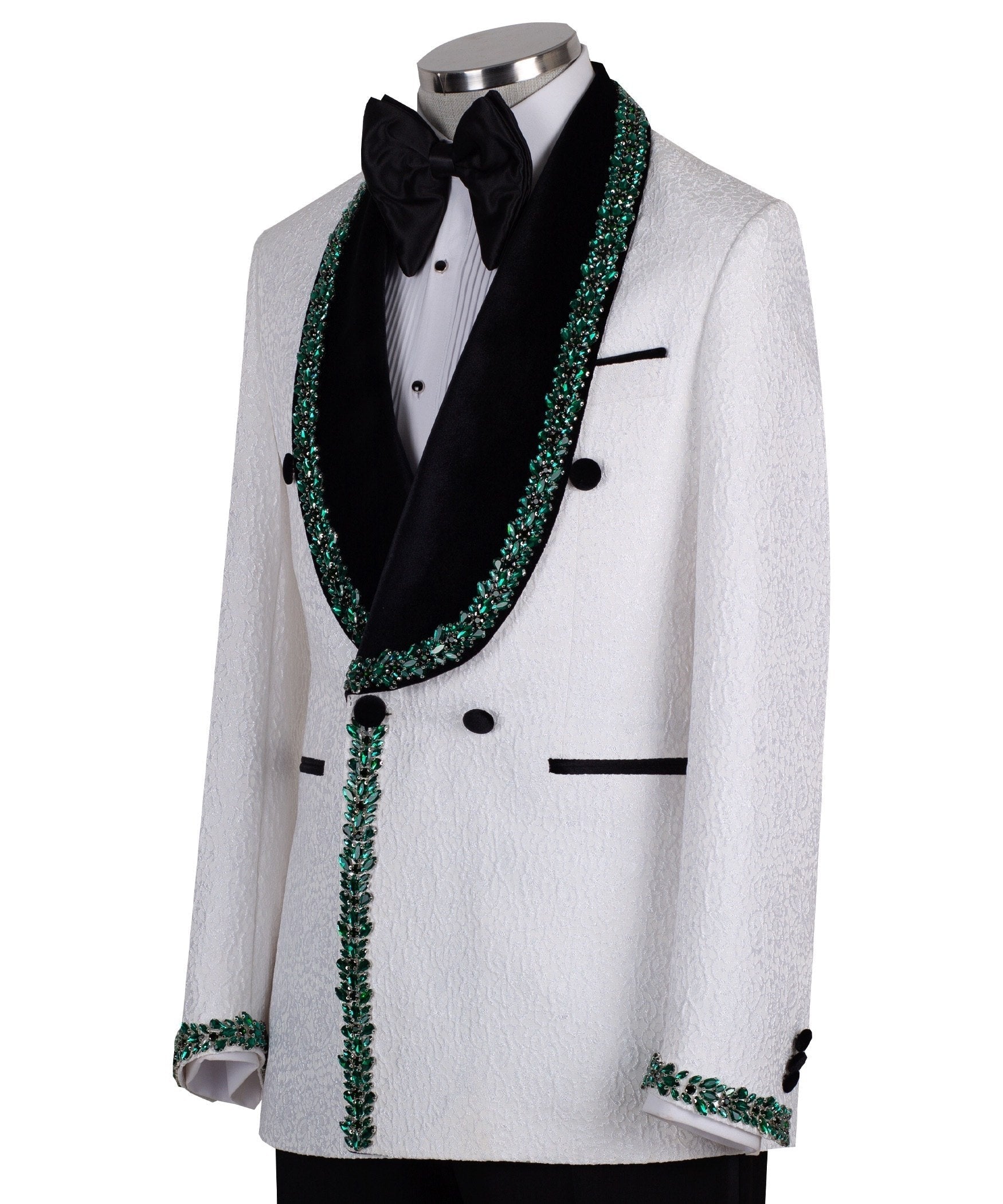 White double-breasted tuxedo jacket with textured fabric, black velvet shawl lapel, emerald green hand-embellished jewels, black buttons, and matching black trousers. Luxurious, handcrafted in Istanbul by Charly Luxury.