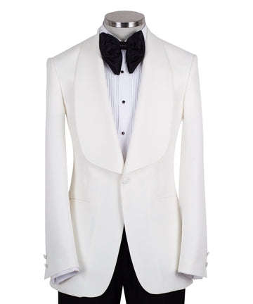 White textured shawl lapel tuxedo jacket and black trousers by Charly Luxury, handcrafted in Istanbul. View shows single-button closure and elegant detailing.