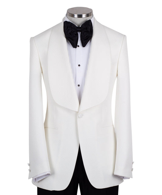 White textured shawl lapel tuxedo jacket and black trousers by Charly Luxury, handcrafted in Istanbul. View shows single-button closure and elegant detailing.