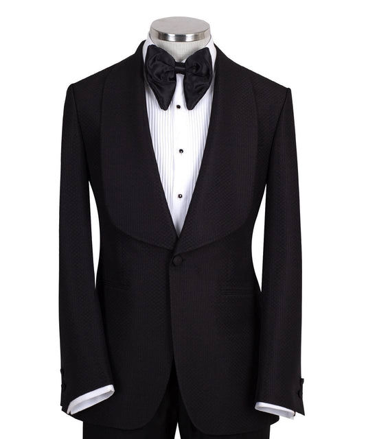Black single-breasted tuxedo with subtle jacquard pattern and elegant shawl lapel, handcrafted in Istanbul by Charly Luxury, front view on mannequin.